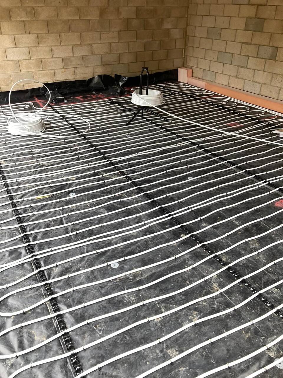 Underfloor heating pipework being installed