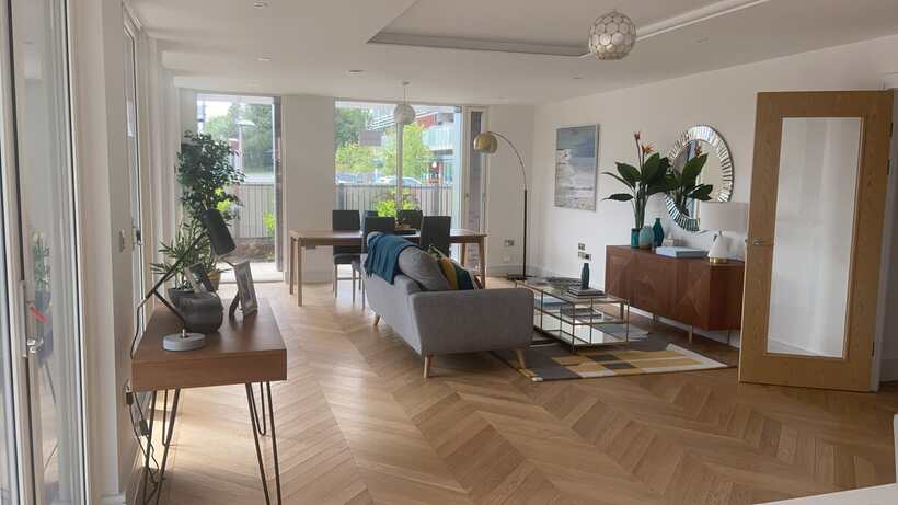 Herringbone flooring through a living and dining space