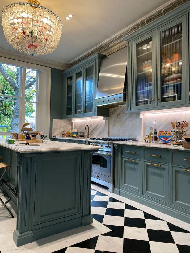 Teal in-frame kitchen with brass range hood