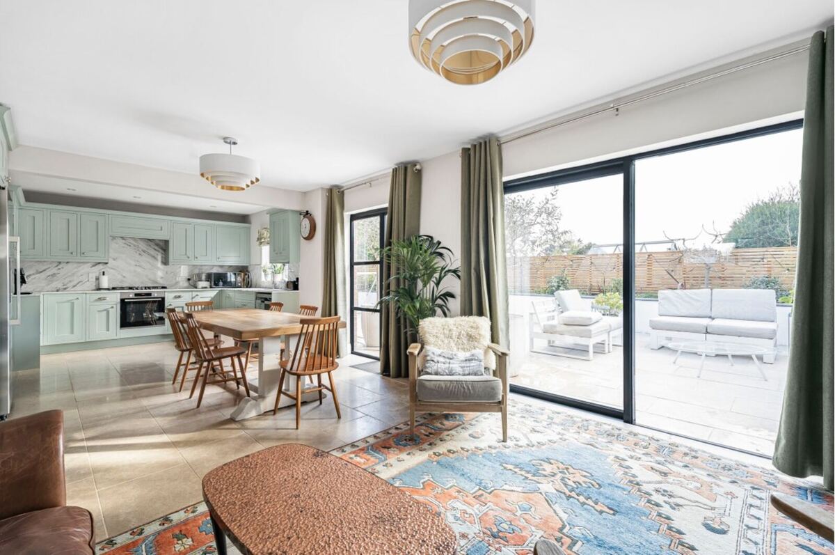 Bright open-plan living and dining space, finished by Cape Build